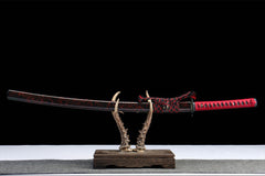Wide studio view of 惊鸿照影 katana and red crackle saya on a wooden stand