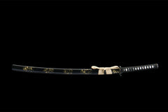 Wide studio view of 断鸿 katana and black gold saya on a wooden stand