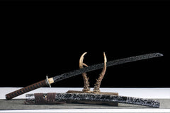 Fenchengjie Katana and scabbard crossed on dark antler display with three-petal silver tsuba