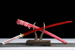 Upper saya close-up of 蚀骨红莲 highlighting the floral crimson finish