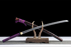 Close-up of 暗夜魔瞳 tsuka wrap with black cotton ito, blue underlay, and bamboo mekugi