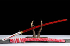 Close-up of 蚀骨红莲 tsuka wrap with white cord and red diamond accents