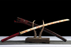 Handle and habaki detail of 惊鸿照影 with the textured tsuba and patterned blade base