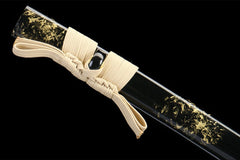 Handle and habaki detail of 断鸿 with dark guard, gold accents, and blade base