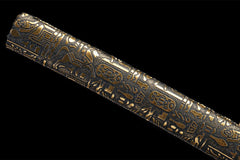 Textured close-up of 噬魂渊 saya under light with embossed decorative pattern