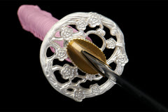 Textured close-up of 霓虹斩 saya under light with its smooth pink lacquer surface